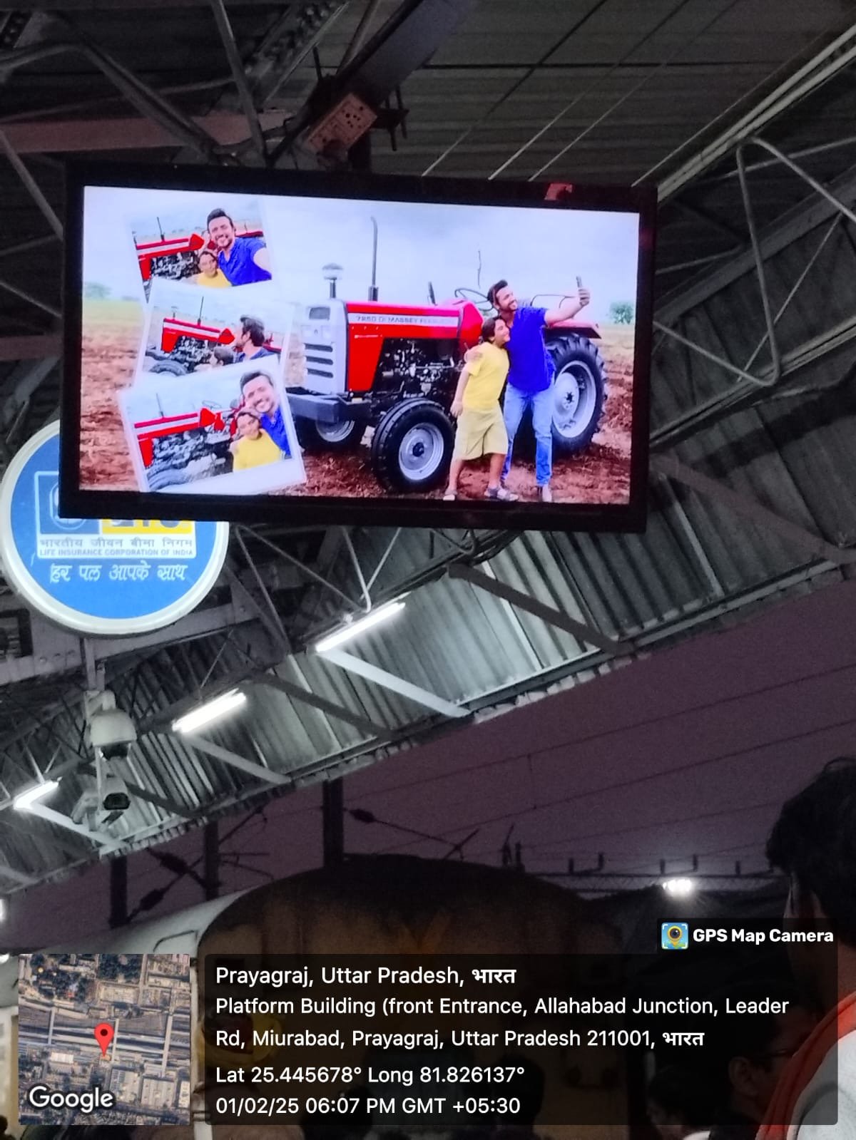 Massey Ferguson advert on an LED screen at Prayagraj Junction, with GPS stamp
