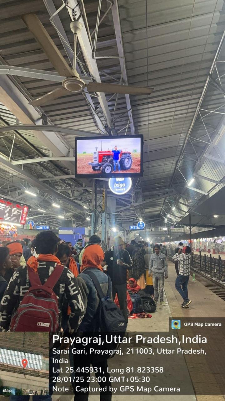Advert on an LED screen at Prayagraj railway station, with GPS stamp